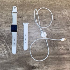 Series 3 Apple Watch, charger, and extra strap